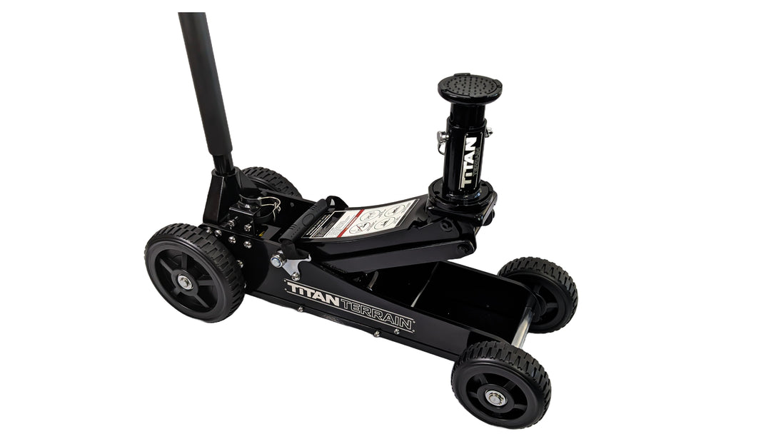 A black rugged floor jack with a hydraulic pump and large wheels designed for off-road conditions.